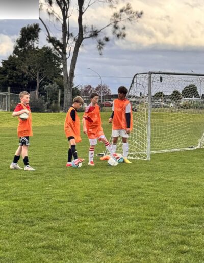 Group soccer development drills with youth players in Papamoa